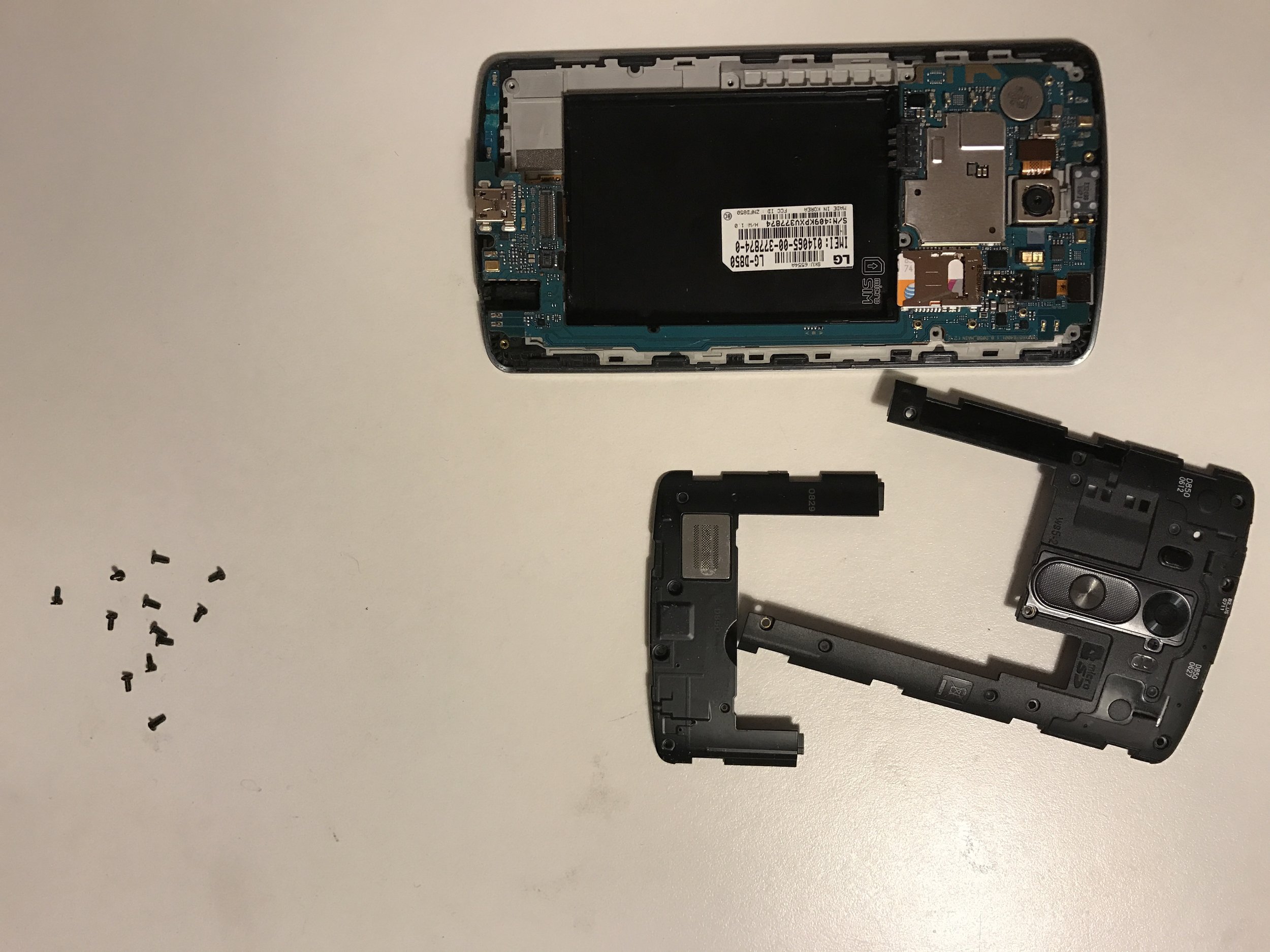 Phone disassembly showing motherboard removal process