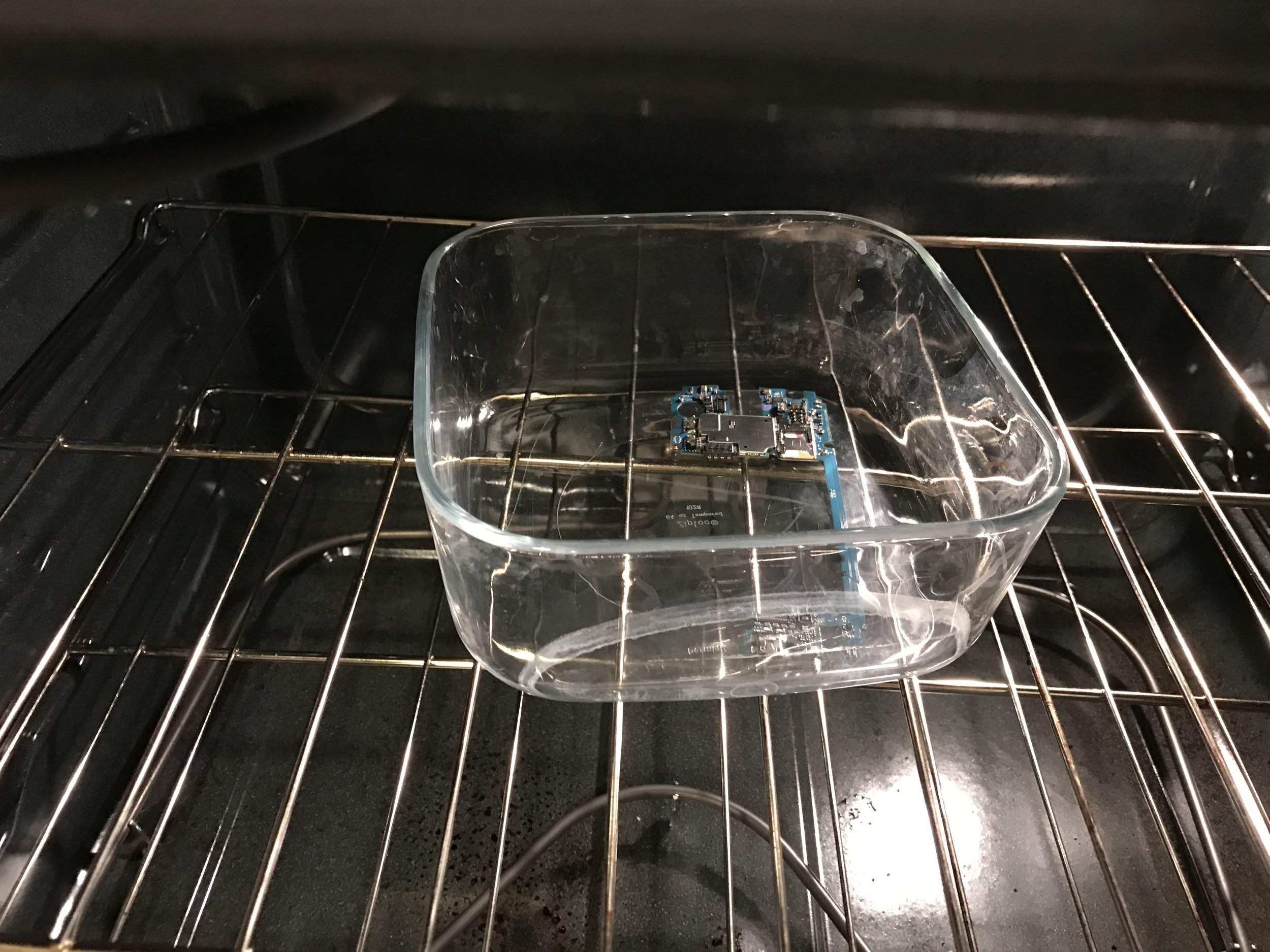 Phone motherboard in Pyrex dish